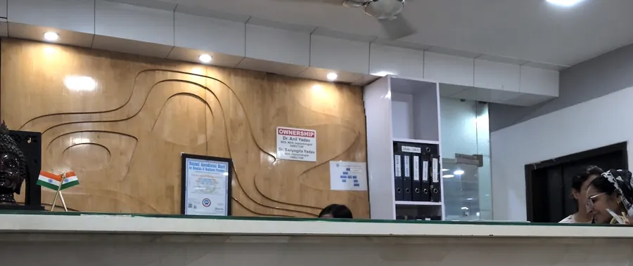 The reception desk, with the ownership board and a framed certificate on the wood panel behind it.
