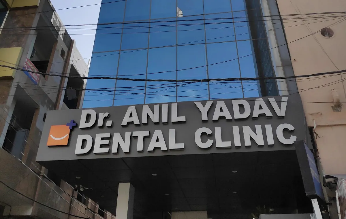 The clinic sign on New Railway Road: Dr. Anil Yadav Dental Clinic in steel letters on a dark fascia.