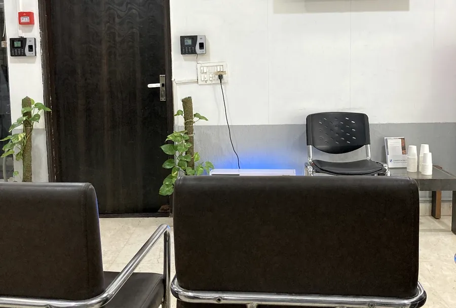 The waiting area, with seating and a screen on the wall.